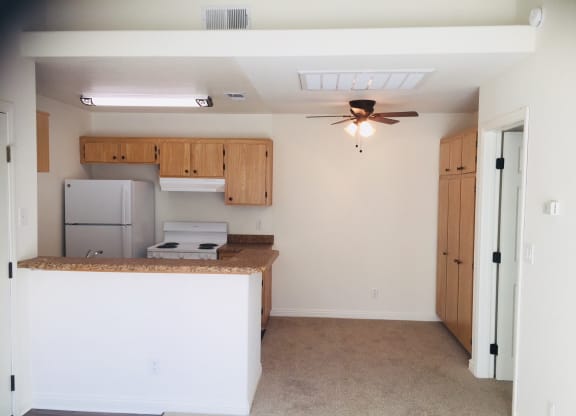 an empty kitchen with a counter and a ceiling fan at Victoria Springs, Riverside, CA 92504