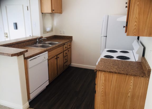 a small kitchen with a stove sink and refrigerator at Victoria Springs, California, 92504