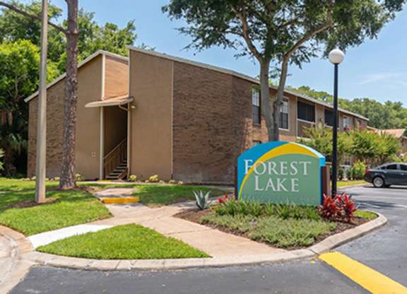 A sign that says Forest Lake in front of a building.