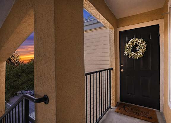 A black door with a wreath on it.