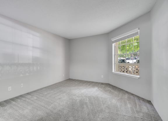 Bedroom With Large Window Overlooking The Patio