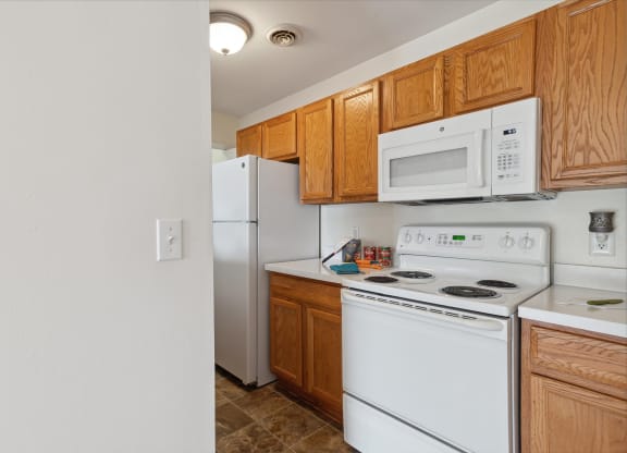 Kitchen with White Appliances and Wood Cabinetry