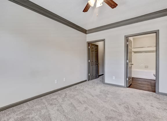 Carpeted Bedroom With Ceiling Fan & Light