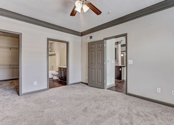 Carpeted Bedroom With Attached Bathroom & Tall Ceilings