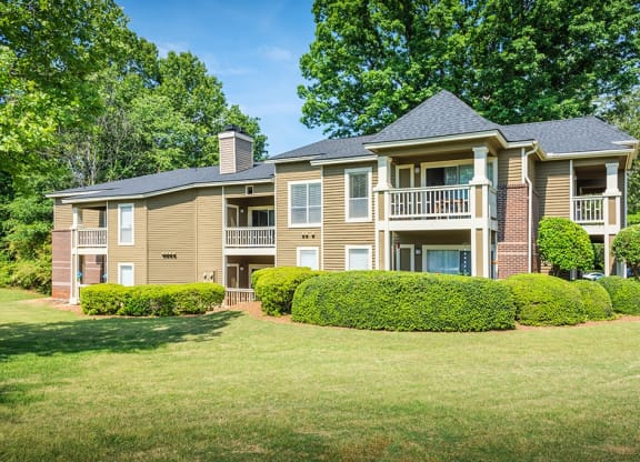 Exterior Of Apartment Homes Overlooking Lush Grass Area