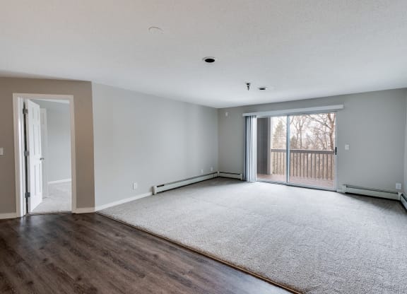 Spacious Living Room with Plush Carpeting with Sliding Patio Door to Balcony