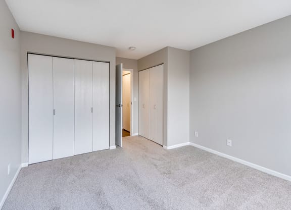 Bedroom with Plush Carpet and Two Closets
