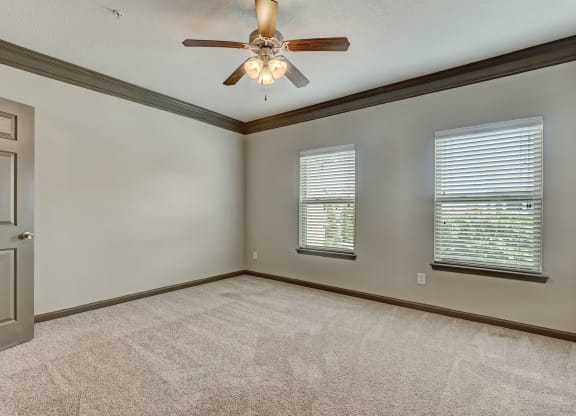 Spacious Carpeted Bedroom With Ceiling Fan & Light