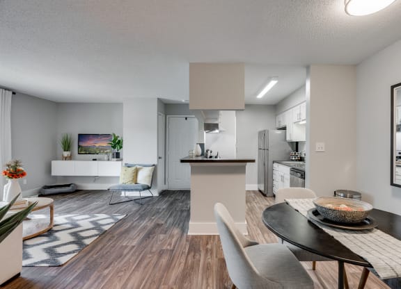 Open-Concept Living With Wood-Style Flooring & White Trim