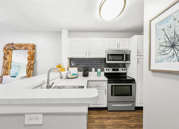 Kitchen Featuring White Cabinets & Stainless Steel Appliances