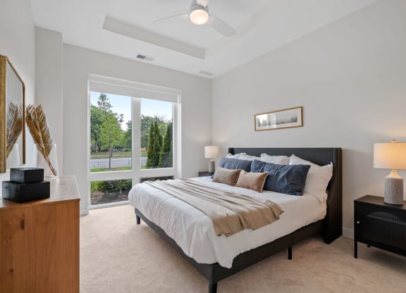 Bedroom Featuring Floor-To-Ceiling Windows With Window Coverings
