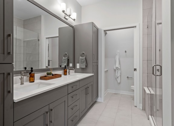 Primary Bathroom Featuring A Double Vanity With Built-In Storage
