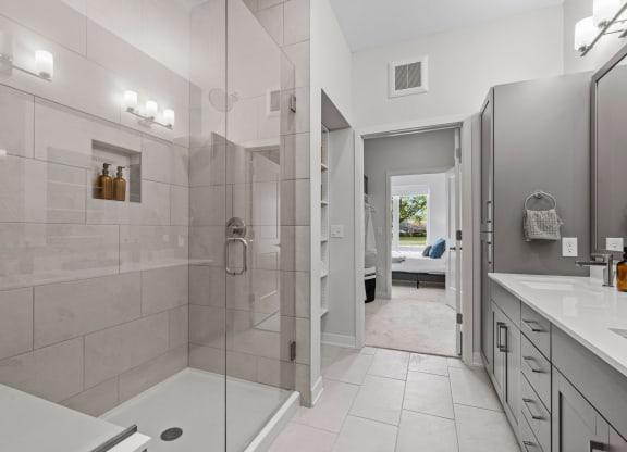 Primary Bathroom Featuring Glass Shower With Bench & Tiled Floor