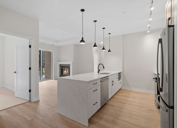 Expansive Kitchen Island with Overhead Lighting