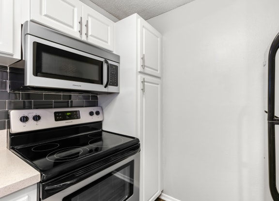 Stainless Steel Appliances & White Cabinets With Pantry