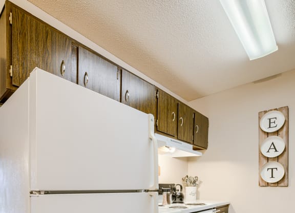 a kitchen with white appliances and a refrigerator
