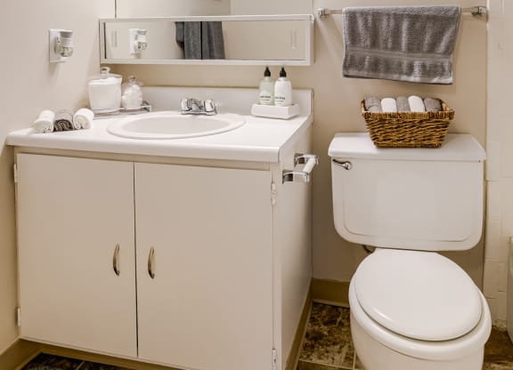 a small bathroom with a toilet sink and mirror