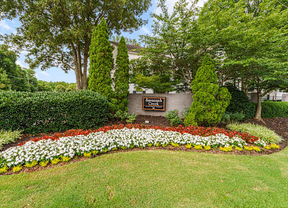 A garden with a plaque in the middle of it.