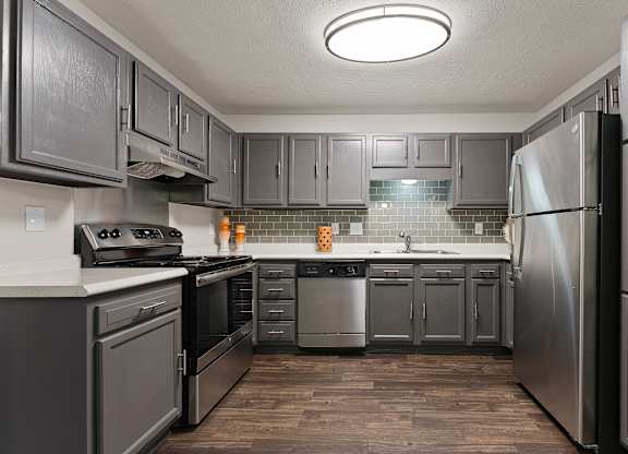 A kitchen with a refrigerator on the right.