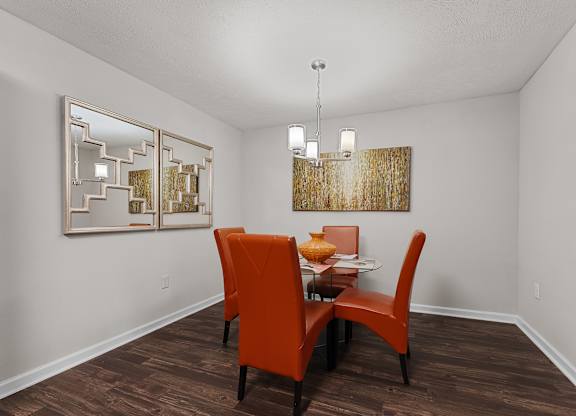 A dining room with wood-style flooring