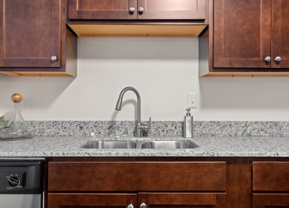 Kitchen with Dark Brown Cabinetry and Stainless Steel Appliances