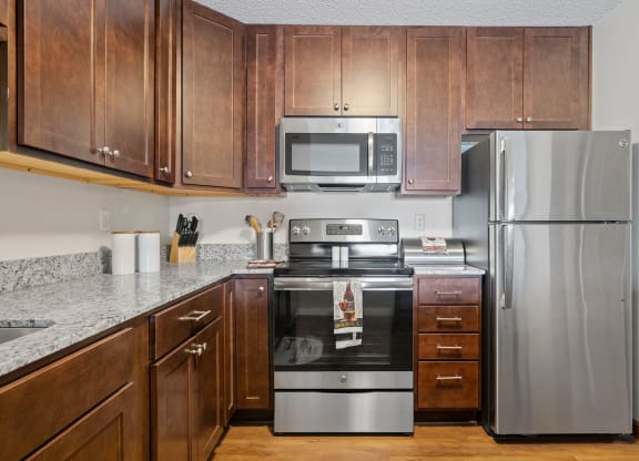 Kitchen with Dark Brown Cabinetry and Stainless Steel Appliances