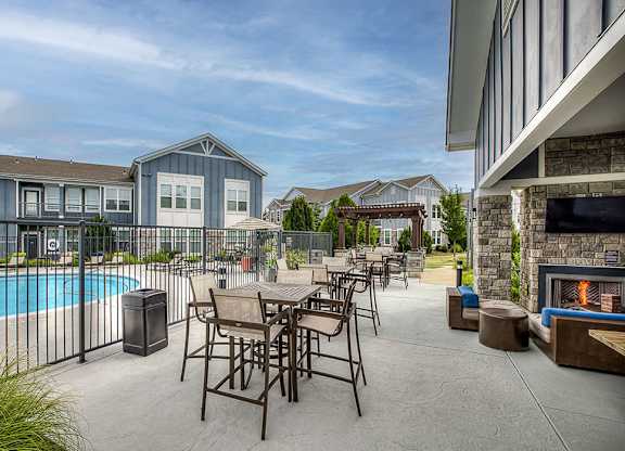 Poolside lounge with seating and fireplace lounge