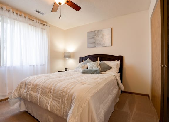Carpeted Bedroom With Ceiling Fan & Light
