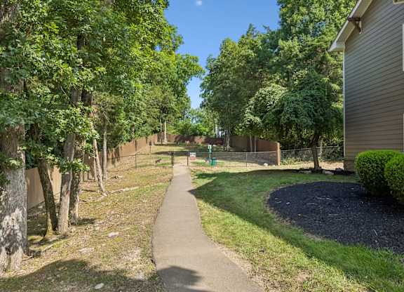 A tree-lined walkway in a residential area.