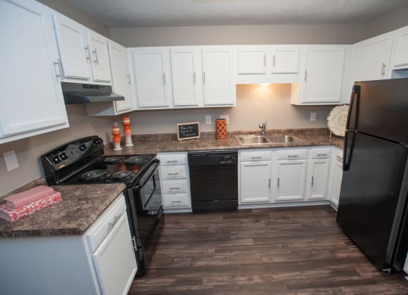 Kitchen with White Cabinetry and Black Appliances