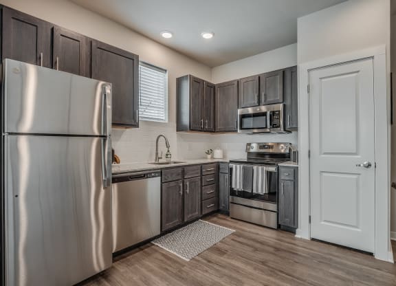 Kitchen with Dark Brown Cabinetry and Stainless Steel Appliances