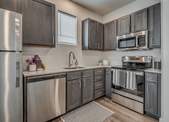 Kitchen with Dark Brown Cabinetry and Stainless Steel Appliances