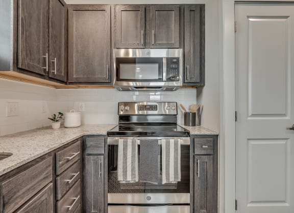 Kitchen with Dark Brown Cabinetry and Stainless Steel Appliances