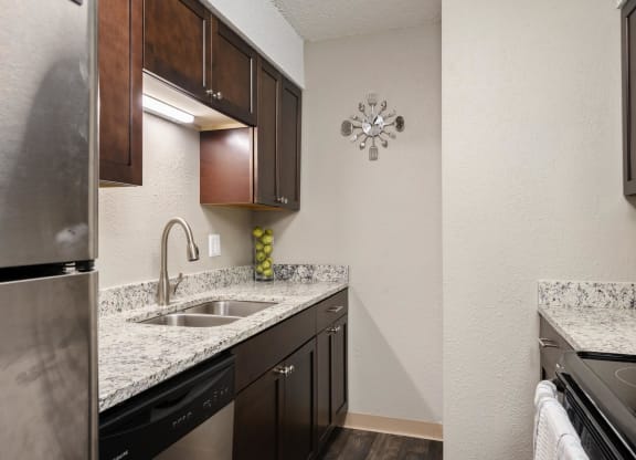 Galley Kitchen With Granite Countertops & Stainless Steel Appliances