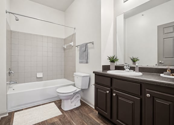 A white bathroom with a white tub and toilet.