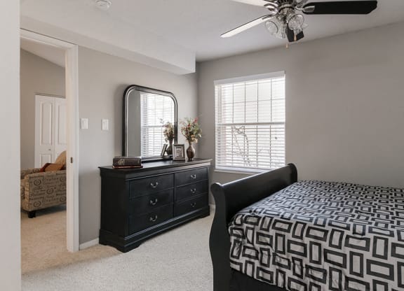 Spacious Carpeted Bedroom with Ceiling Fan