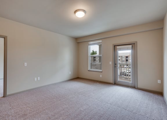 Spacious Living Room with Large Window and Glass Patio Door