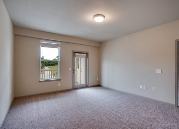 Spacious Room with Plush Carpet and Glass Patio Door