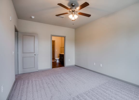 Bedroom with Ceiling Fan and Attached Bathroom