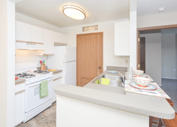 Kitchen with White Appliances and Breakfast Bar