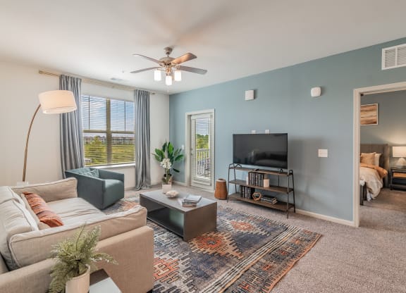 Spacious Living Room With Glass Patio Door Leading Out To Balcony