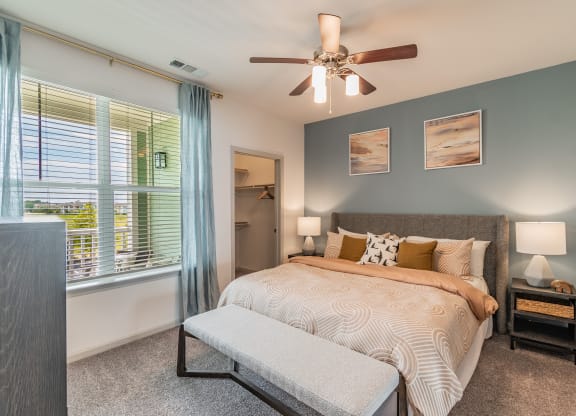 Bedroom With Large Windows & Built-In Window Treatments