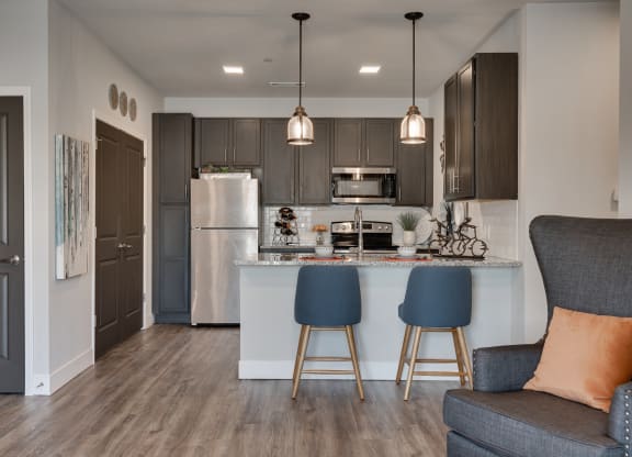 Kitchen With Stainless Steel Appliances & Breakfast Bar