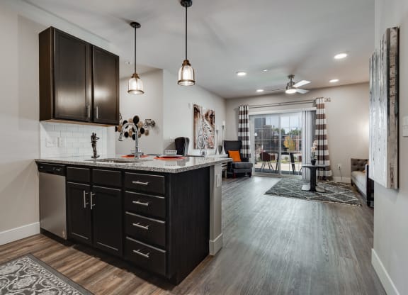 Large Kitchen Island With Granite Counters & Stainless Steel Dishwasher