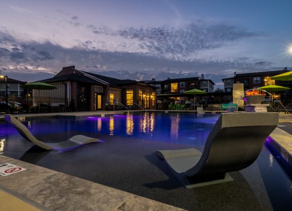 Sun Lounger Chairs In The Pool At Night