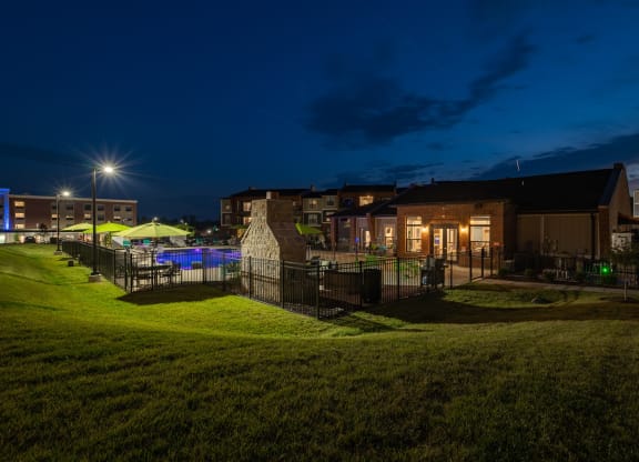 Clubhouse Overlooking The Fenced-In Pool & Sundeck At Night