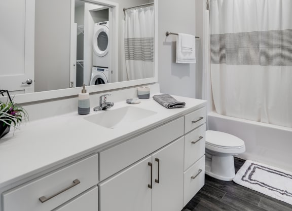 Spacious Bathroom with White Cabinetry