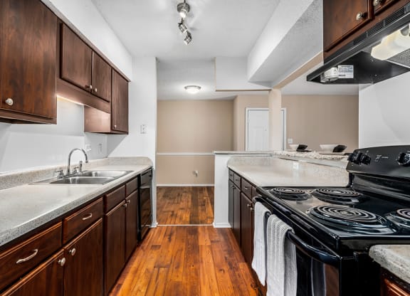 Galley Kitchen With Black Appliances & Espresso Cabinets