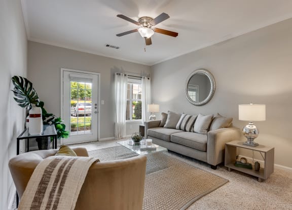 Living Room Featuring Tall Ceilings & Lots Of Natural Light