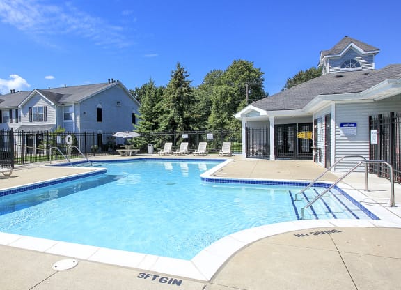 Fenced-In Outdoor Pool with Lounge Furniture